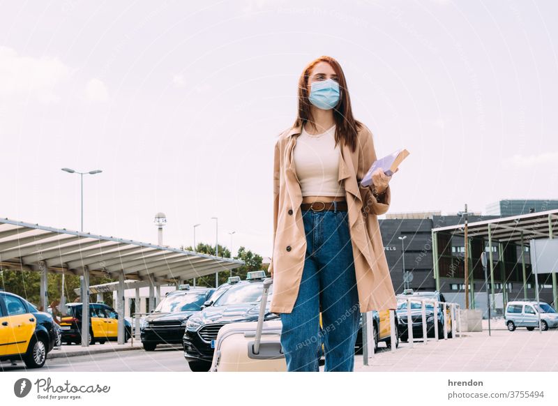 young woman with luggage arrives at the train station by cab coronavirus voyage traveling transportation public journey tourist trip commuter economy epidemic