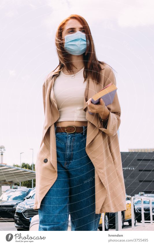 young woman with luggage arrives at the train station by cab coronavirus outbreak journey transport traveling public tourist trip commuter transportation voyage