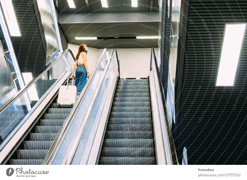 young tourist with face mask uses subway escalator stairway terminal coronavirus tourism transportation public journey trip commuter train staircase traveling