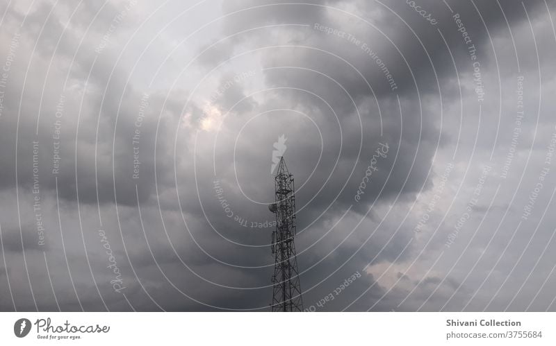 Telecommunication tower with ominous stormy clouds abstract background. Copy space nature and environment and technology concepts. climate cloudscape cloudy