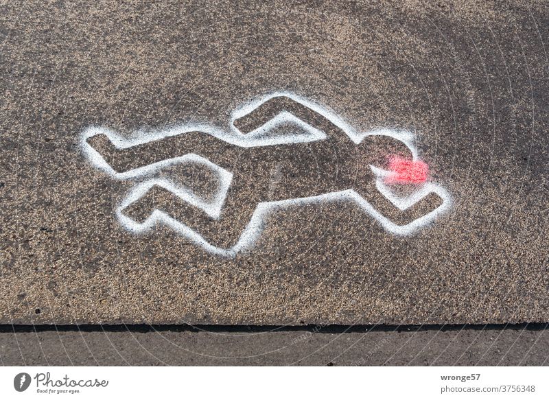 Crime scene road | outlines of a person lying on the road marked with white spray paint on black asphalt Street Asphalt white color silhouettes sketched Lie