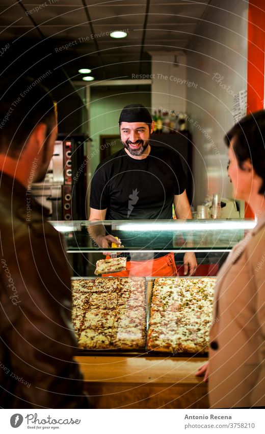 Young couple buying pizza at night restaurant fast food bar. man turkish ale adult person people attractive men male bearded seller store junk food business