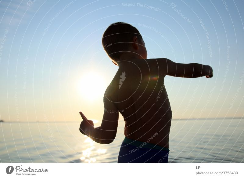 contrast silhouette of a child against sea and sky Contrast Shallow depth of field Silhouette Shadow Light Day Exterior shot Action Body Boy (child) Human being