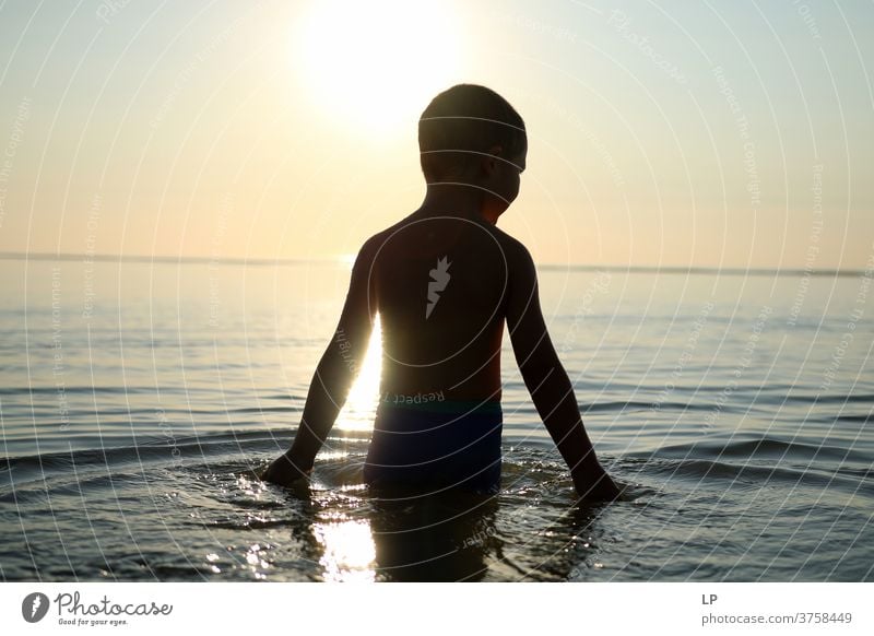 contrast silhouette of a child against sea and sky Contrast Shallow depth of field Silhouette Shadow Light Day Exterior shot Action Body Boy (child) Human being