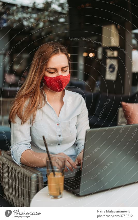 Blonde woman with mask working on laptop in coffee shop adult attractive beautiful beauty business businesswoman cafe caucasian communication coronavirus