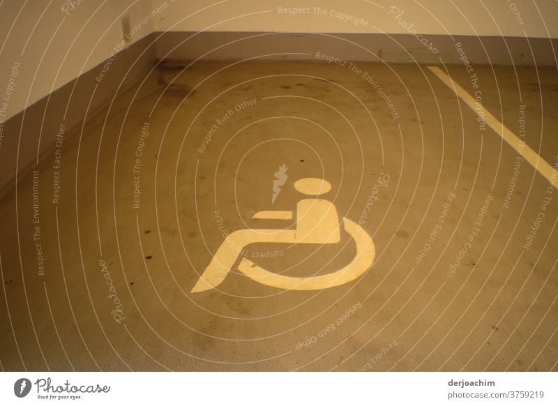Reserved for the disabled is the parking space in the underground garage. With a lying wheelchair picture drawn on the floor. garage entrance Parking garage