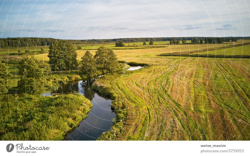 Autumn landscape in evening sunlight from above. Agriculture fields after harvest tree autumn fall river sunny water September nature reflection blue aerial