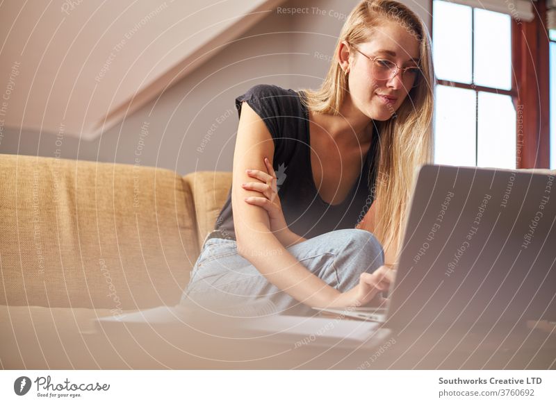 Young woman working on laptop at home businesswoman communication lifestyle indoor young caucasian happy house interior smile computer casual indoors female