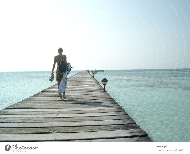 footbridge into the sea Footbridge Beach Ocean Maldives Summer Woman blue water