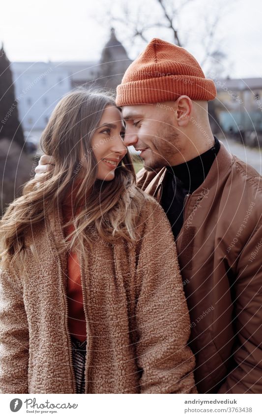 young happy couple on old city background. A love couple enjoying a walk in the courtyard of the old city. Against the background, red brick walls. selective focus