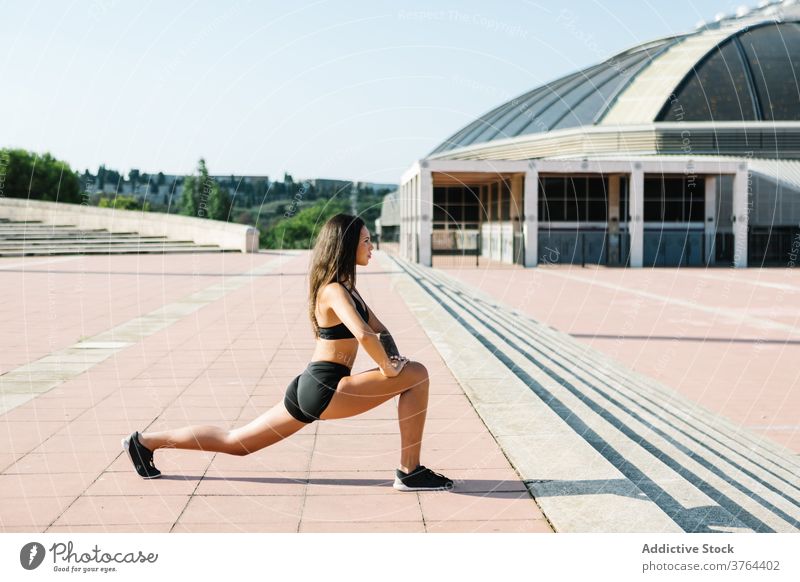 Athletic black woman doing exercises on street - a Royalty Free Stock Photo  from Photocase