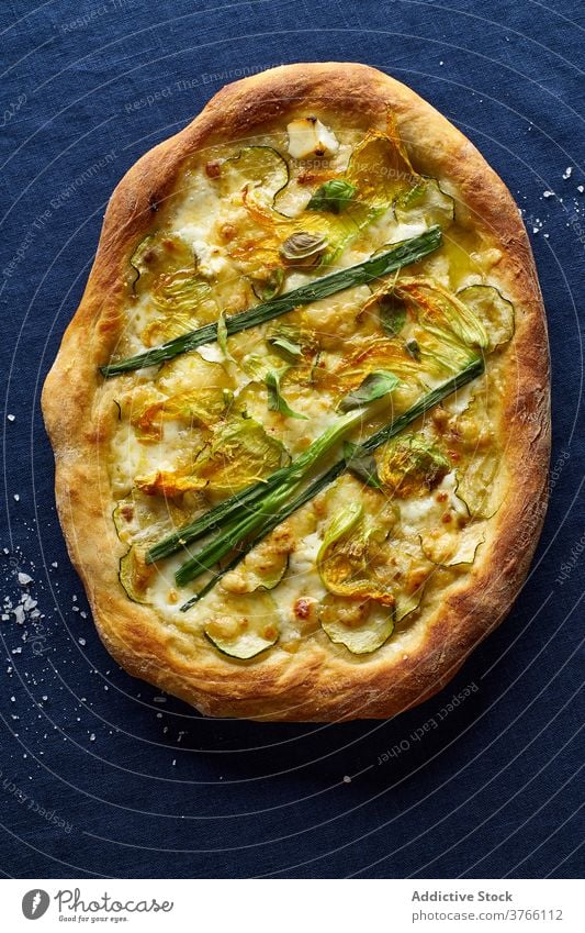 Top view of vegetarian pizza zucchini onion blue orange wine cheese crust salt italian cuisine food meal flatlay top view overhead zucchini flowers rustic