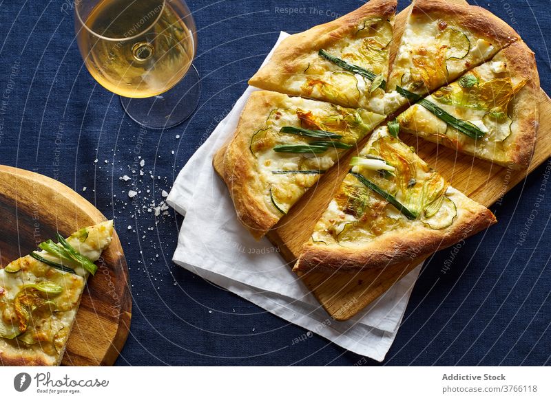 Top view of vegetarian pizza zucchini onion blue orange wine cheese crust salt italian cuisine food meal flatlay top view overhead zucchini flowers rustic