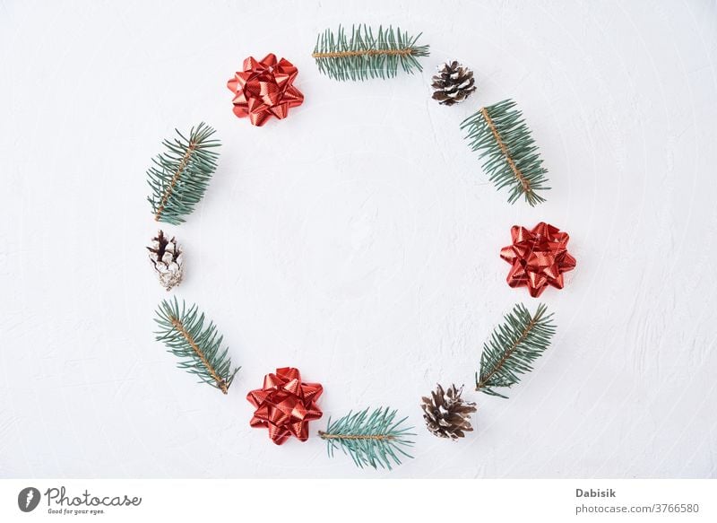 A wreath of Christmas tree branches with a red - Stock