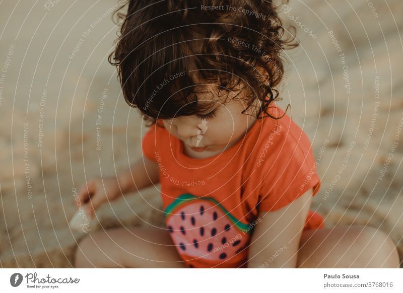 Little girl playing in the Sandy beach Beach Child Children's game Childhood memory Playing Beach vacation Ocean Colour photo Exterior shot Vacation & Travel