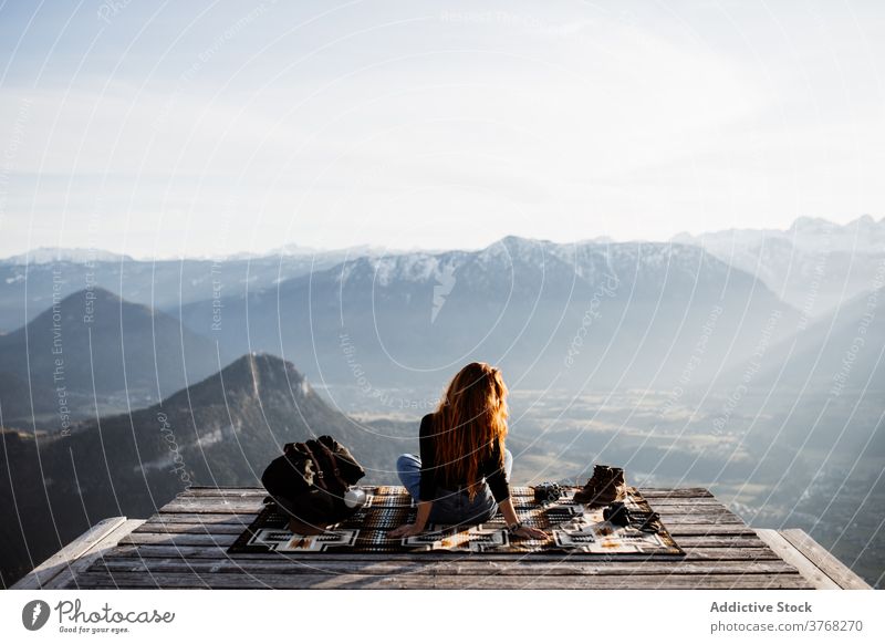 Traveling woman on wooden terrace in highlands viewpoint mountain morning traveler fog sunbeam tranquil enjoy germany austria tourist scenery amazing adventure