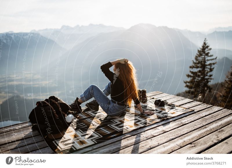 Traveling woman on wooden terrace in highlands viewpoint mountain morning traveler fog sunbeam tranquil enjoy germany austria tourist scenery amazing adventure