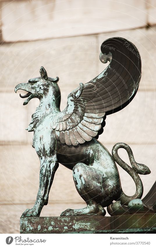 A Greif sculpture in front of the parliament in Vienna. Sculpture Figure Bronze Metal gryphon Mixing mythical Mythology Lion bird of prey Beak Grand piano