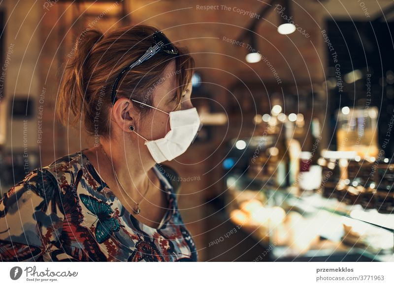 Young woman shopping in grocery store, wearing the face mask to avoid virus infection caucasian conversation covid-19 lifestyle outbreak outdoors pandemic