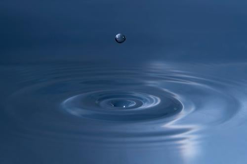 Water drop above wavy surface water wave liquid macro close up shape splashing spheric abstract aqua aquamarine aquatic background ball bead blue bright bubble