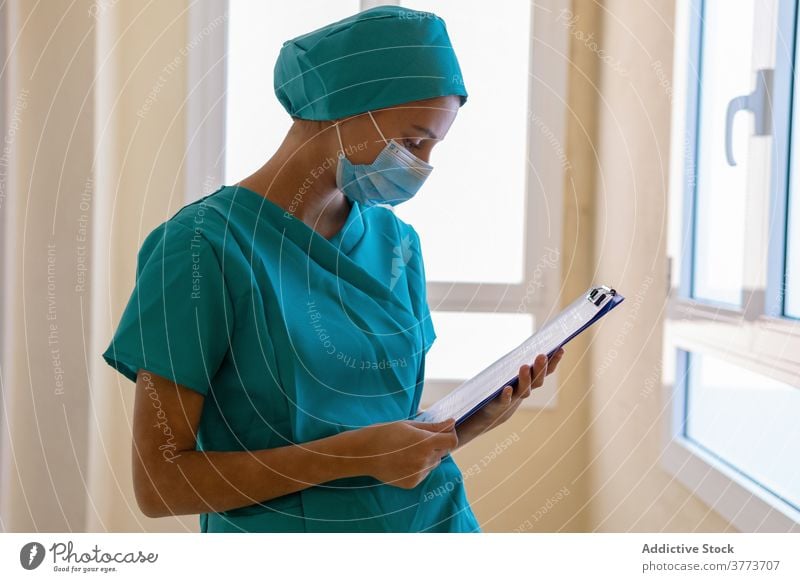 Nurse writing on clipboard in hospital nurse write take note medic woman clinic work medical young female professional medicine occupation staff health care