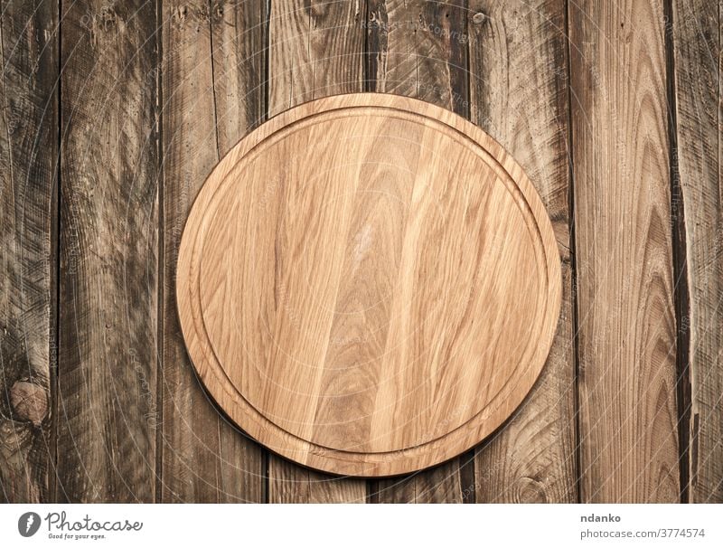new empty round wooden cutting board on gray table above backdrop background blank circle closeup cloth domestic equipment food handcrafted hardwood household