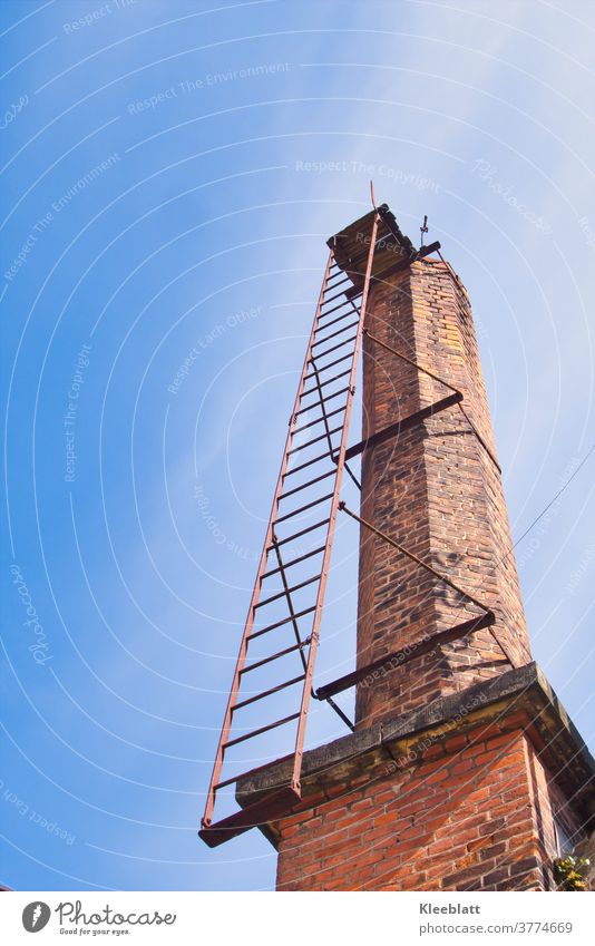 Old factory chimney made of red bricks with rusty ladder rises into the blue-white sky - Lost Place Factory fireplace Architecture Exterior shot Wall (barrier)