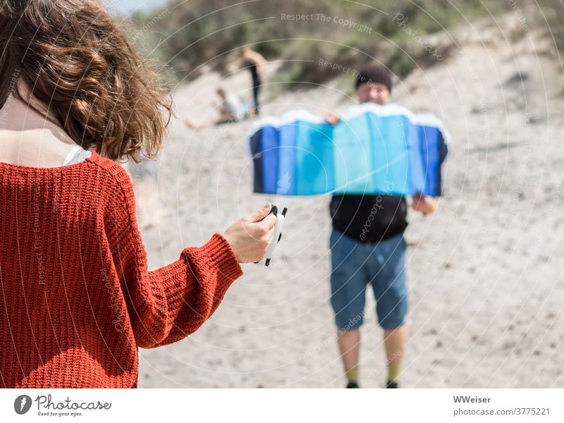 Kite flying requires a good coordination between father and daughter kites Wind Beach Sun Flight Mat steering mat Father Girl Daughter Child Curl hair Sweater