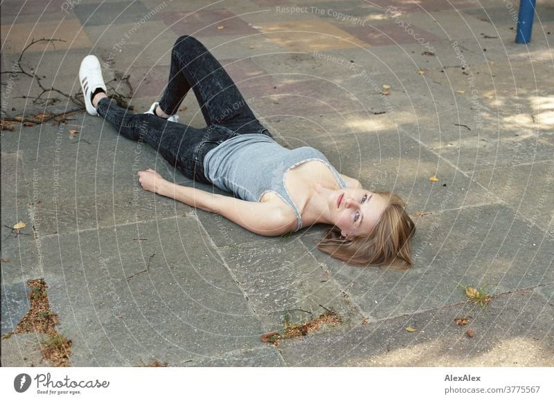 Portrait of a young woman lying on the floor and looking up into the camera Woman Young woman Slim already athletic Blonde youthful 18-25 years red blonde hair