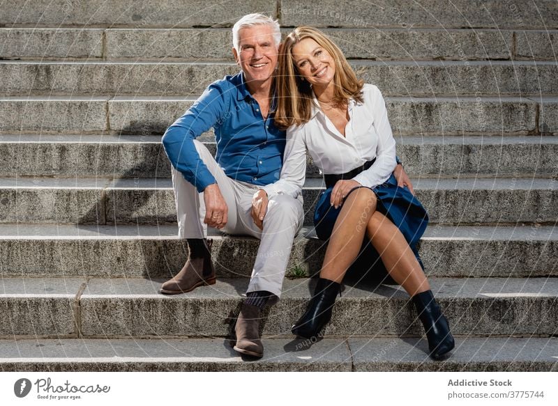 Loving couple on stairs in city love relationship adult together in love tender cheerful stone relax affection embrace bonding romantic close enjoy smile mature