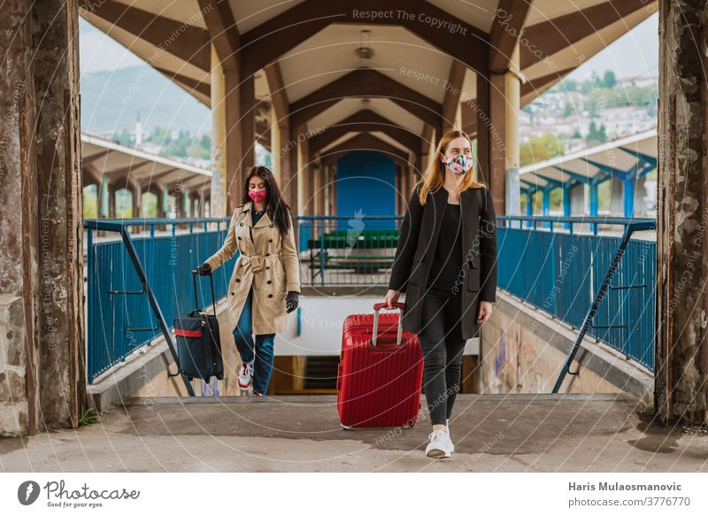 woman traveling with luggage bag and face mask architecture background beautiful building city color colorful coronavirus covid-19 culture destination europe