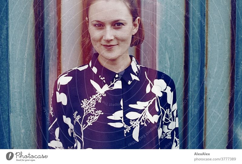 analogue, cropped portrait with false colours of a young woman in front of a rusty trapezoidal sheet metal wall Woman Young woman already Slim Blouse