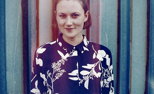 analogue, cropped portrait with false colours of a young woman in front of a rusty trapezoidal sheet metal wall Woman Young woman already Slim Blouse