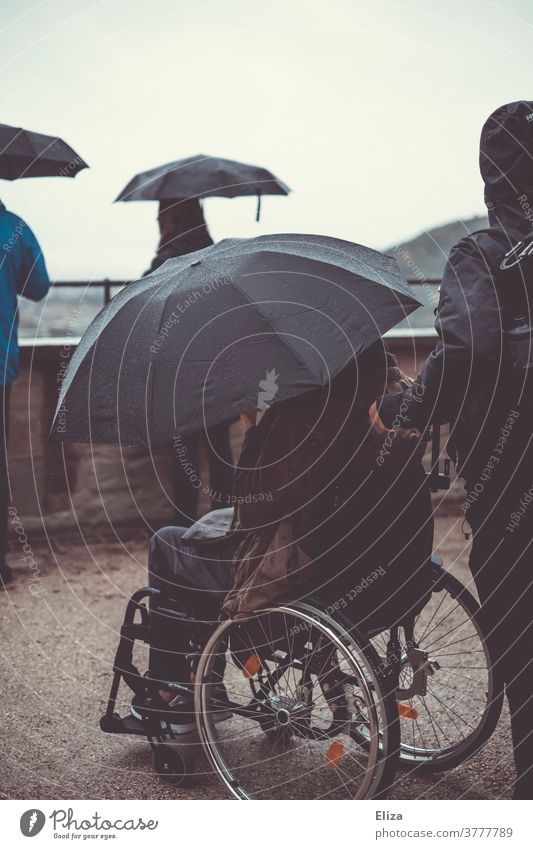 Trip with wheelchair and umbrella because it is raining and the weather is bad. Wheelchair Rain Umbrella Weather barrier-free Vantage point Sightseeing Autumn