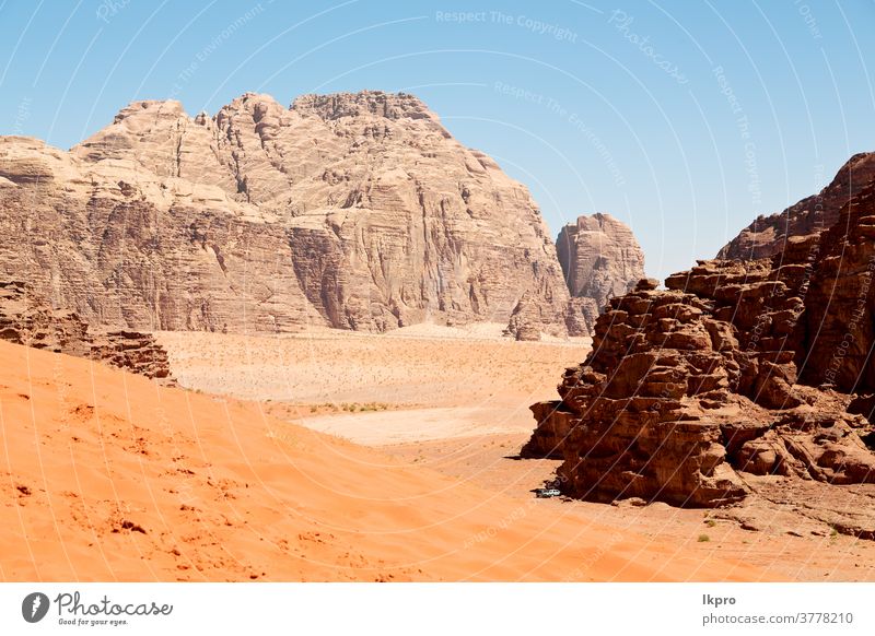 in the desert  sand and mountain adventure destination rum wadi jordan landscape nature valley sky red east rock middle tourism dry natural travel background