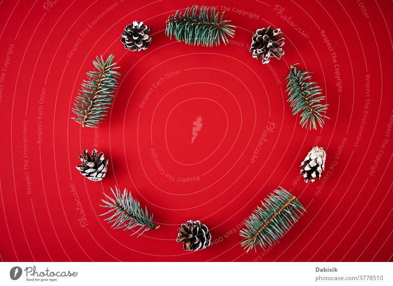 Christmas composition. Wreath made of fir tree branches and festive pine cones on a red background, top view christmas decoration wreath holiday new year xmas