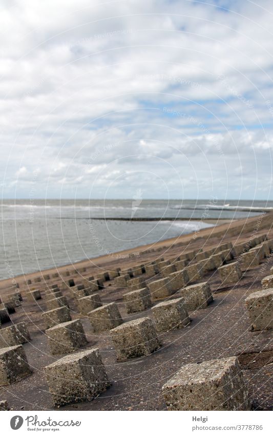 Küstenschutz - Concrete blocks as breakwaters at the dike of Wangerooge, in the background the North Sea coastal protection Dike dyke protection Water Polder