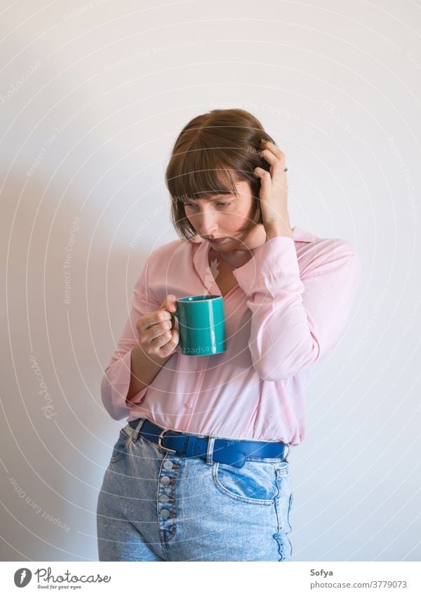 Young sad woman drinking coffee and thinking young depression stress stressed feeling worried psychology mental unhappy lonely pink serious thoughtful depressed