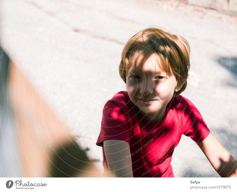 Little boy playing outdoors in summer lifestyle child authentic kid freedom bike nature face smiling sun fun little portrait cute joy blonde sunlight caucasian