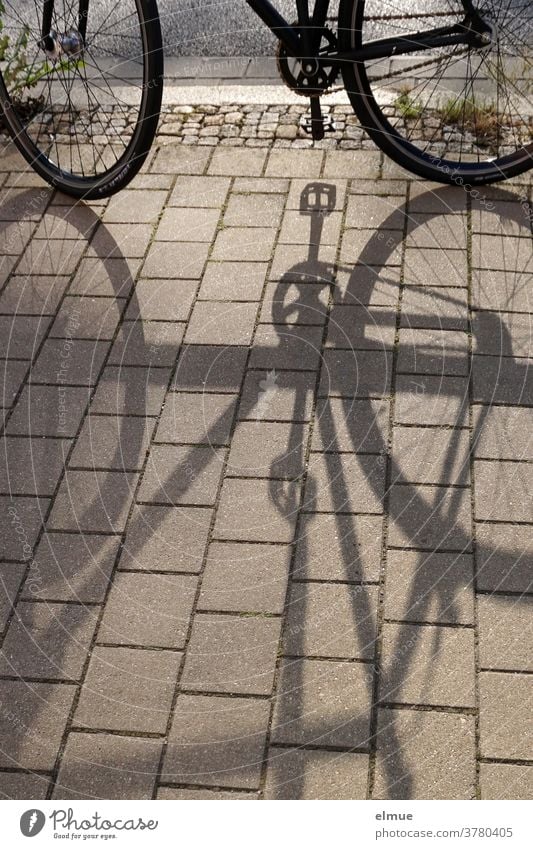 While the shade of his parked bicycle grew longer and longer, the time until the beer garden bar was closed was steadily decreasing ... Bicycle Shadow