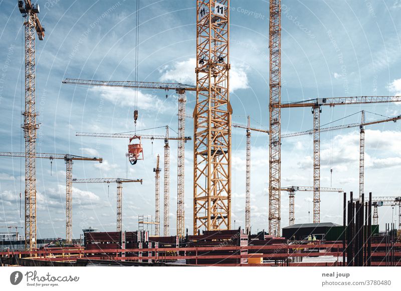 Construction site with many cranes Build create Crane Exterior shot Sky Blue sky Industry Work and employment Technology Tall Future Economy Growth Workplace