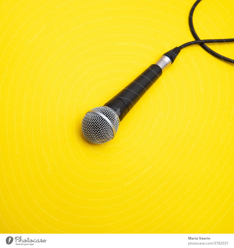 Mic Drop Microphone micro Music Concert String Hand microphone Yellow colored background Copy Space Rock music Podcast recording take