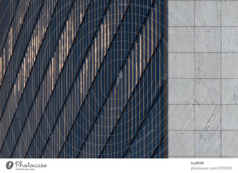 the setting sun is subtly reflected in the facade of the high-rise Abstract Glass Facade Financial Industry Architecture Building High-rise Design Reflection