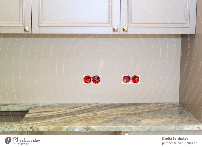 marble countertop with cutout for sink or hob in modern classic kitchen. Wall sockets with exposed electrical wires removed before installing marble facing of kitchen wall