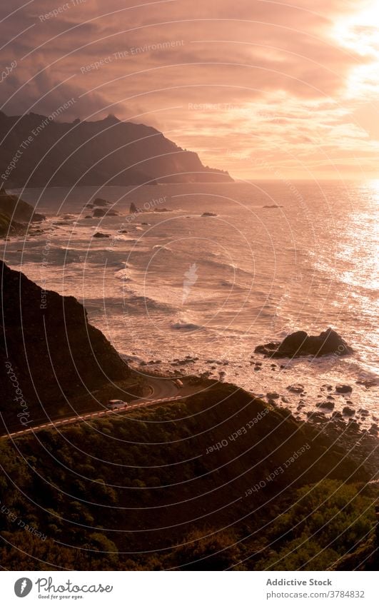 Amazing scenery of sea in evening seascape sunset orange vibrant rock mountain shore sky amazing tenerife spain canary islands water picturesque vacation ocean