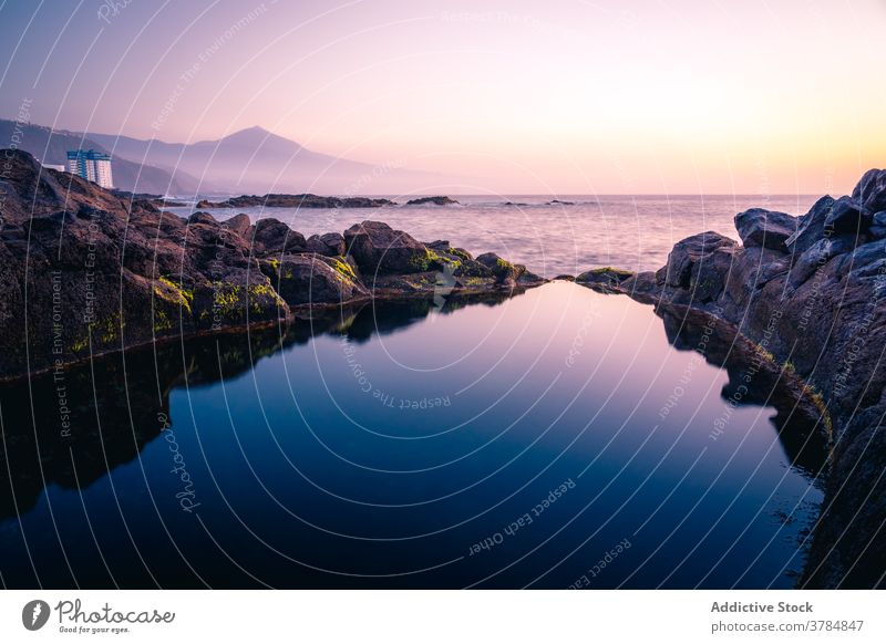Clear pond near rocks at sunset water seascape landscape amazing clear transparent scenic canary islands spain tenerife small reflection coast tranquil calm