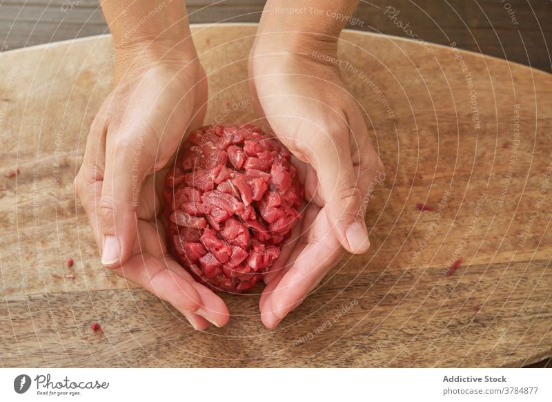 Crop female cook preparing Steak tartare steak tartare raw beef woman chef meat tradition kitchen round shape ingredient knife cuisine food prepare fresh dish