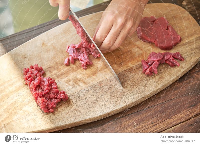 Crop woman cutting meat in kitchen beef cook steak tartare housewife prepare dinner dish female cutting board chopping board fresh wooden cuisine knife culinary