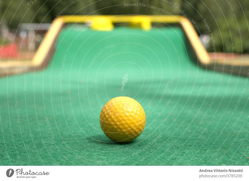 close up on a minigolf ball on the course with copy space for your text outdoor outside no people nobody color image fine art print wall print play playing fun