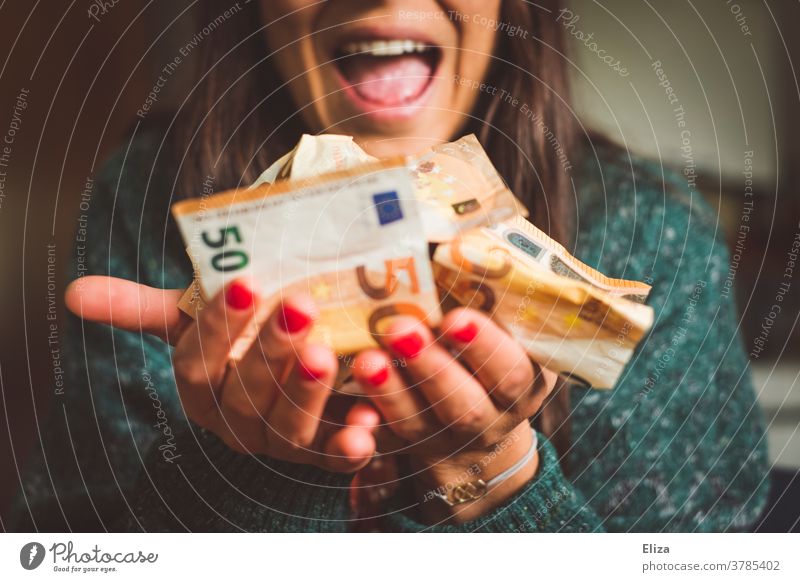 A woman holds a lot of money in her hand and is visibly happy about it. Wealth, success, profit. Money Luxury Bank note Many Joy Loose change Euro Success